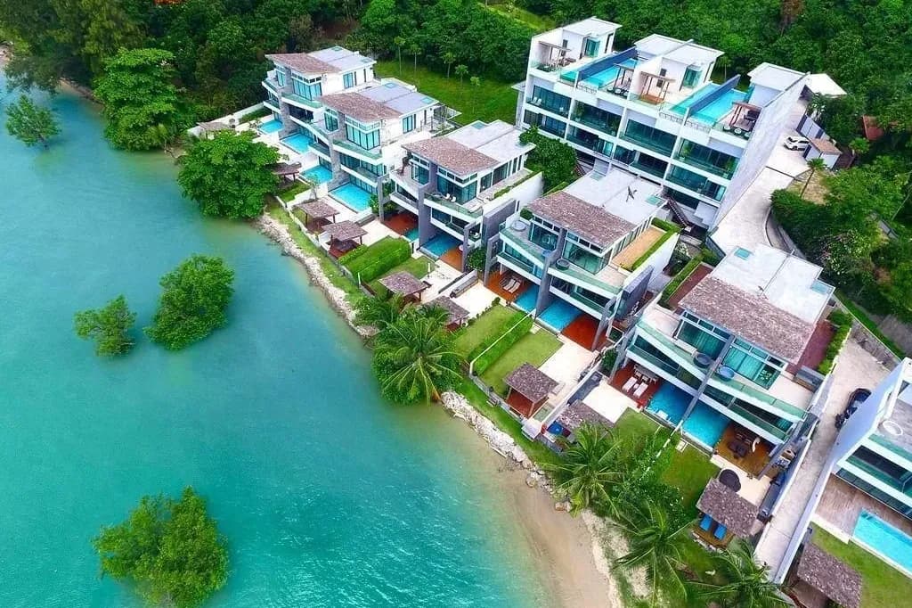 Aerial view of sea-view pool villas on the waterfront in Rawai