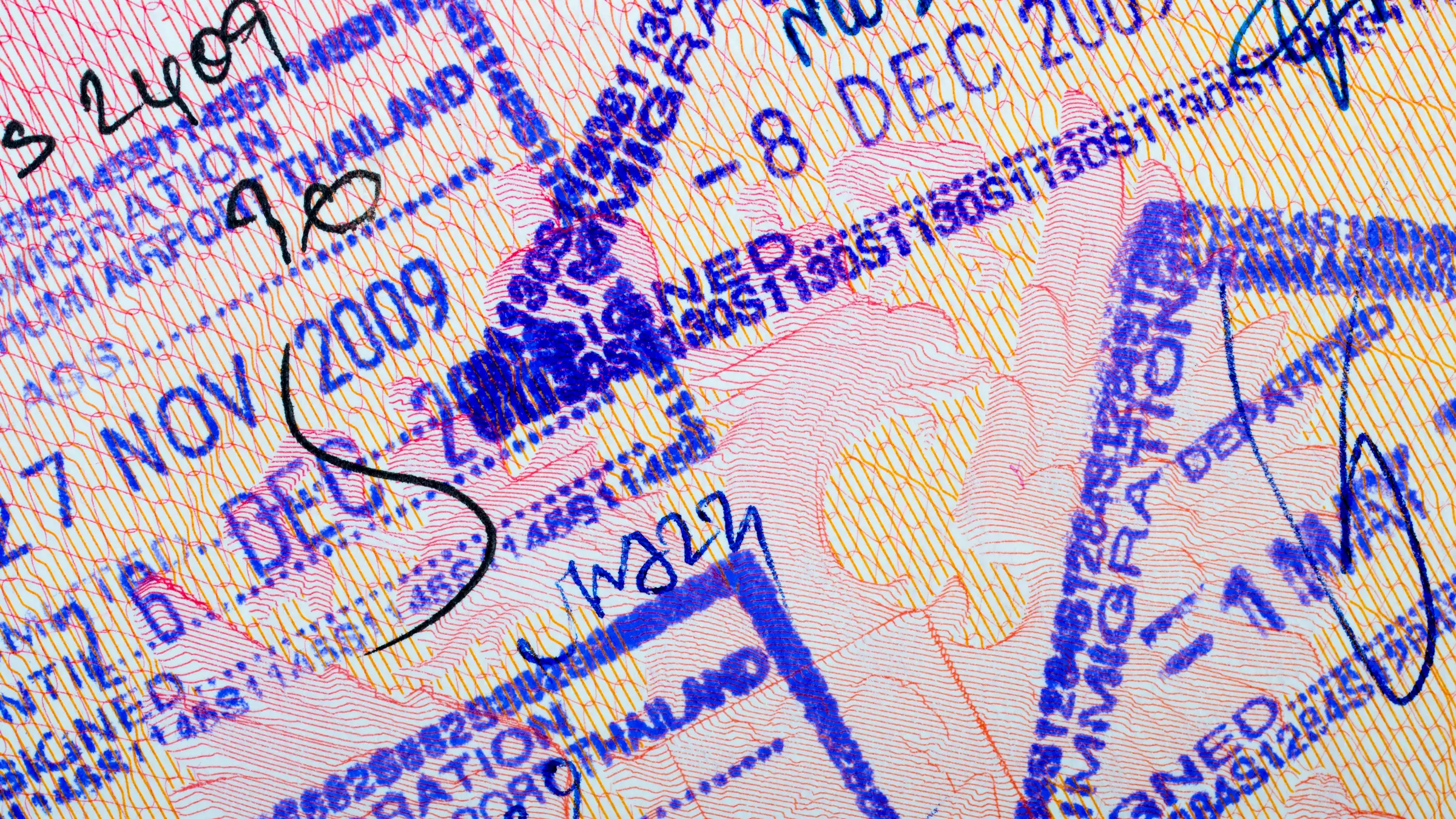 Close-up of a passport page covered in Thai immigration entry and departure stamps