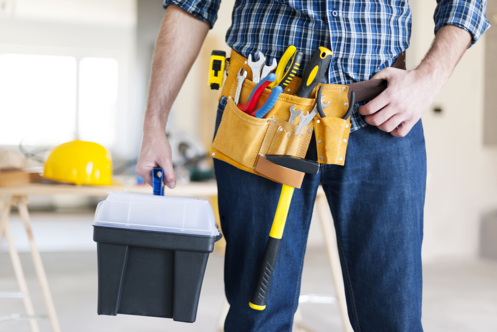 House maintenance worker holding toolbox and tools belt for property care in Phuket